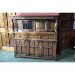 An Old Charm oak court cupboard, carved frieze, cup and cover supports, glazed leaded lights,