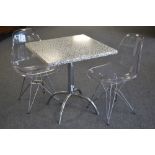 A Werzalit table and chairs, with black and white top, chrome base, stamped,