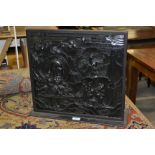 A Chinese rectangular hardwood panel, carved in relief with a scene from mythology, 40cm high,