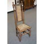An oak hall chair, padded back flanked by turned pilasters, finialed turned uprights.