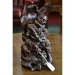 A Chinese hardwood carving, of a sage seated on an elephant, 31cm high,