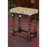 An early 20th century oak bobbin turned stool