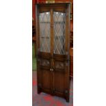 A York Rose dark oak corner cabinet, with astral glazed door to top, panelled oak door to back, c.