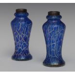 A pair of silver mounted blue iridescent glass vases,