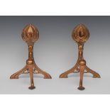 A pair of Art Nouveau copper andirons, stylised organic crestings,