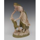 A Royal Dux model, mother and child, playing, oval base, picked out in green, pink and gilt,