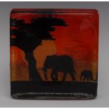A large Caithness rectangular paperweight, Elephants, in silhouette on a red and orange ground, 16.
