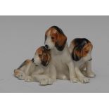 A Royal Worcester animal model, of three foxhound puppies, printed crown and circle mark in black,