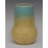 A Ruskin bulbous vase, drip glazed in pastel shades of blue and yellow, 21cm high, impressed mark,