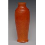 A Pilkingtons Royal Lancastrian slender baluster vase, glazed throughout in bright mottled orange,