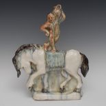 An unusual Art Pottery flatback model, of a water carrier standing on horseback,