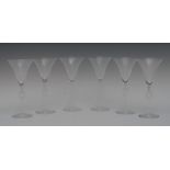 A set of six Lalique wine glasses, flared bowls, the stems pierced with geometrical blocks,