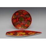 A Poole Aegean pattern leaf shaped dish, typically glazed in rich shades of red, orange and yellow,