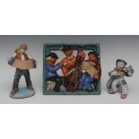 A Continental Art Pottery figure, of a traveller playing an accordion, 26cm high; another,