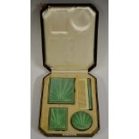 An Art Deco silver vanity set, engine turned enamel in green with sun burst motif,