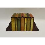 A Huntley and Palmer biscuit tin in the form of books between two bookends