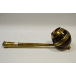 A 19th century coconut shell dipper or ladle