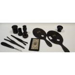 An early 20th century ebony dressing table set, comprising hand mirror, tongs, ring tree,