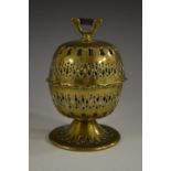 A George III brass pierced globular string box, surmounted by a steel cutter, 13cm high, c.