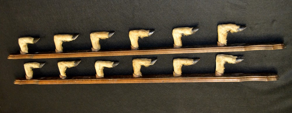 A country house taxidermy two-piece crop rack, formed of twelve deer fetlocks, shaped mounts,