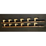 A country house taxidermy two-piece crop rack, formed of twelve deer fetlocks, shaped mounts,
