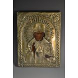 A 19th century Russian Orthodox gilt and painted icon, depicting a saint in benediction,