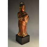 A Chinese lacquer figure, of an immortal, in the typical Ming manner,