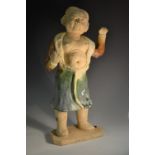A Chinese terracotta figure, of a youth of the Han dynasty, poised for combat,