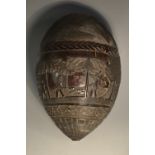 A Colonial 'bugbear' coconut flask, carved in relief with European figures hunting deer,