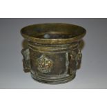 An 18th century bronze mortar, cast with a band of crowns interspersed with shaped lugs, 9.