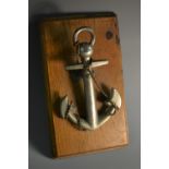 An early 20th century silvered metal novelty desk clip, as an anchor, oak base, 15cm long, c.