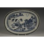 A Chinese porcelain elongated oval dish, decorated in underglaze blue with a landscape of pagodas,