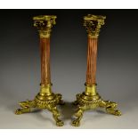 A pair of 19th century brass and copper candlesticks, incurved square beeded nozzles,