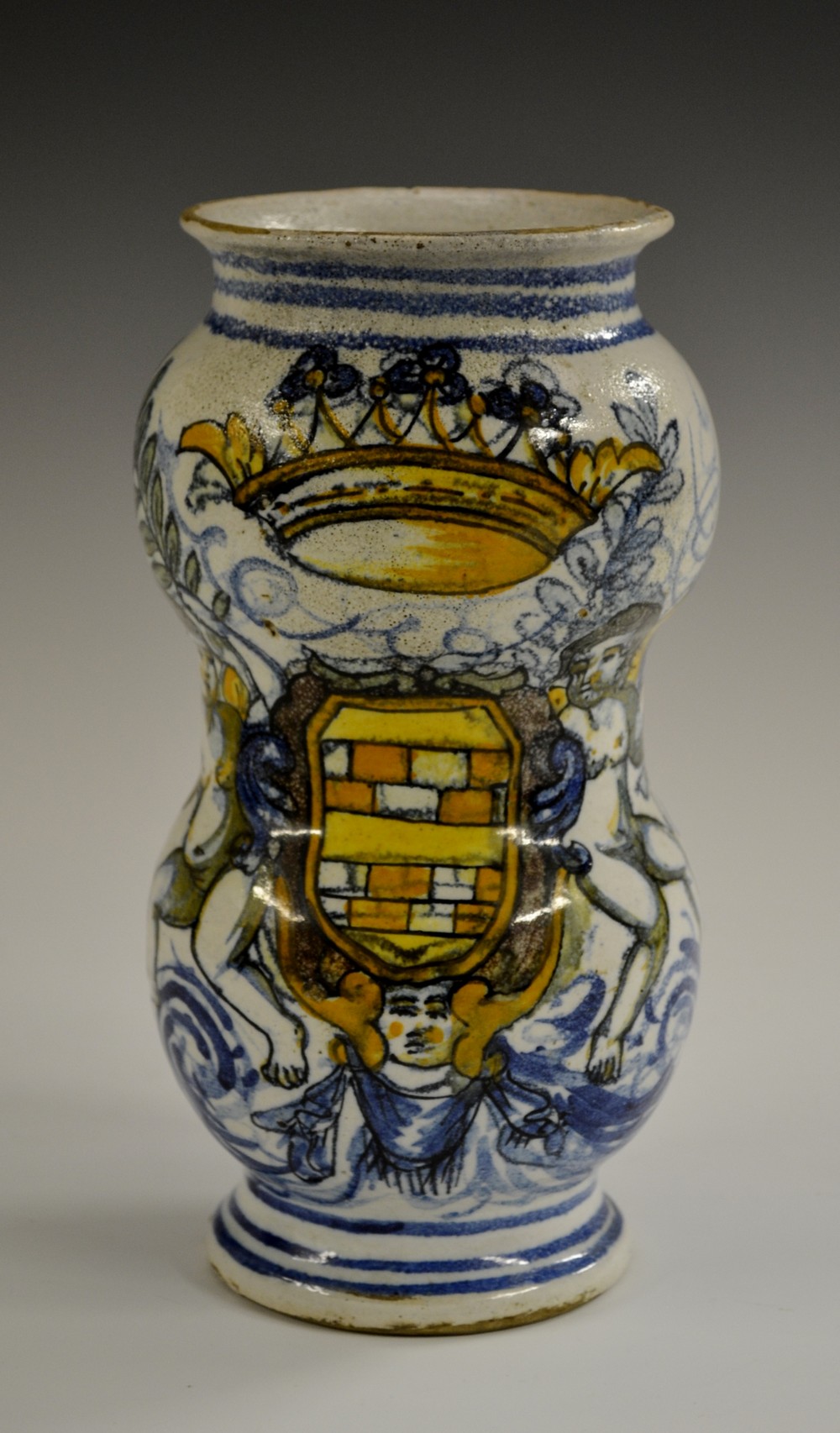 A maiolica albarello drug jar, of waisted form, decorated in tones of blue, yellow,