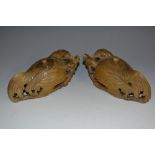 A pair of Chinese soapstone water droppers and covers, carved as a pair of recumbent cockerels,