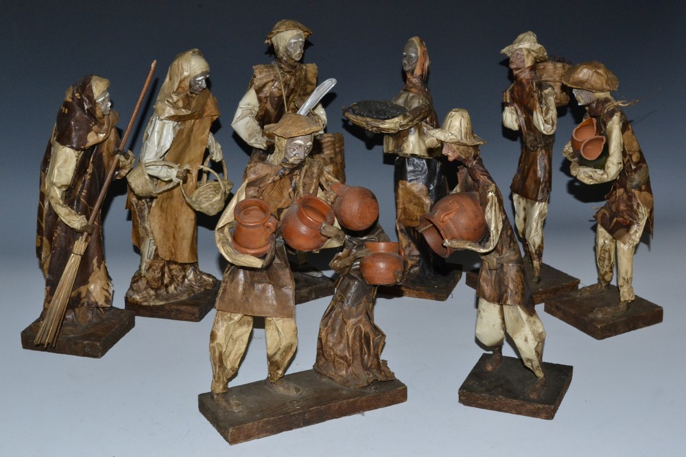 A collection of Mediterranean papier mache and composition figures, of peasants,
