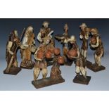 A collection of Mediterranean papier mache and composition figures, of peasants,