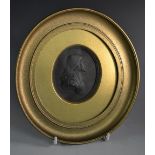 A 19th century Wedgwood black basalt oval portrait medallion, of John Wesley,