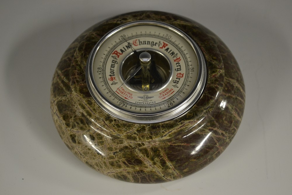 A Cornish serpentine aneroid barometer, 7.5cm register, turned border, 14.