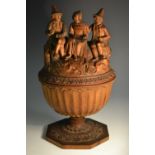 A Black Forest goblet and cover, carved with Tyrolean figures, the side with layered leaves,