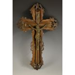 A 19th century bronze and hardwood corpus Christi, the cross carved with a border of leafy scrolls,