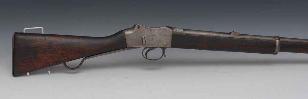 A Martini Henry breach-loading rifle, 82cm sited barrel, the lock marked Enfield 1888,