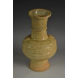 A Chinese celadon baluster vase, moulded in low relief with lion masks and scrolls, girdle to neck,