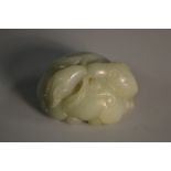 A Chinese pale celadon jade carving, of entwined rams, in the archaic taste, 5.