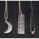 A silver ingot on neckchain; a silver crescent moon;