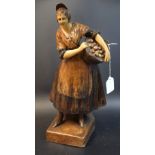 A terracotta figure, lady with basket of oranges,