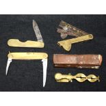 A set of cased brass sovereign scales; a Goergian three blade fleam;