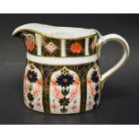 A Royal Crown Derby 1128 pattern cream jug