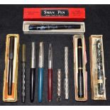 A collection of pens, including a Swan fountain pen,