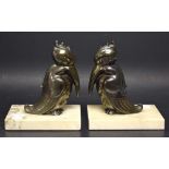 A pair of Art Deco spelter and white marble bookend, as stylized Birds,